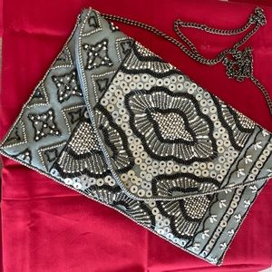 Silver sequin evening clutch, optional 18” strap, excellent condition.